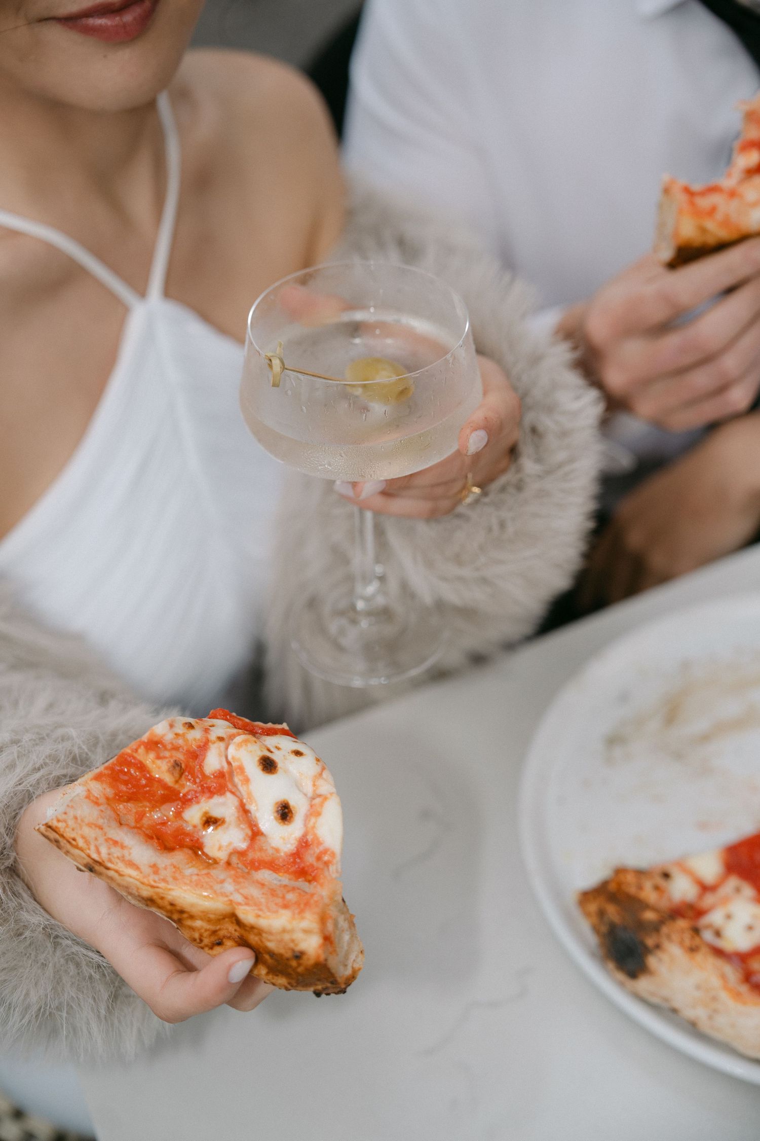 Close-up shots of wedding reception meal showing plates with food and cocktail glasses.