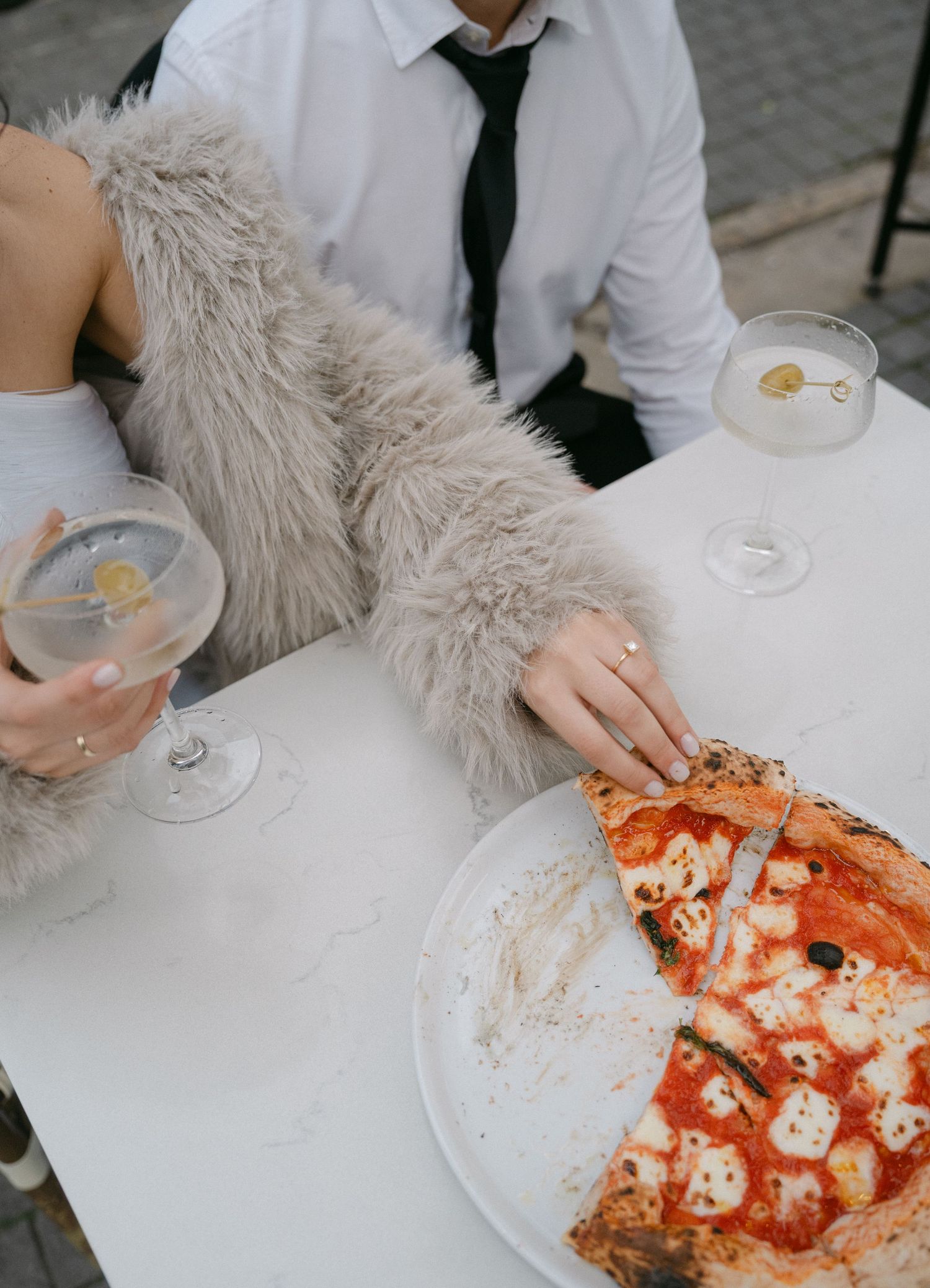 Close-up view of a traditional Neapolitan pizza with red sauce and fresh mozzarella on a white tablecloth.