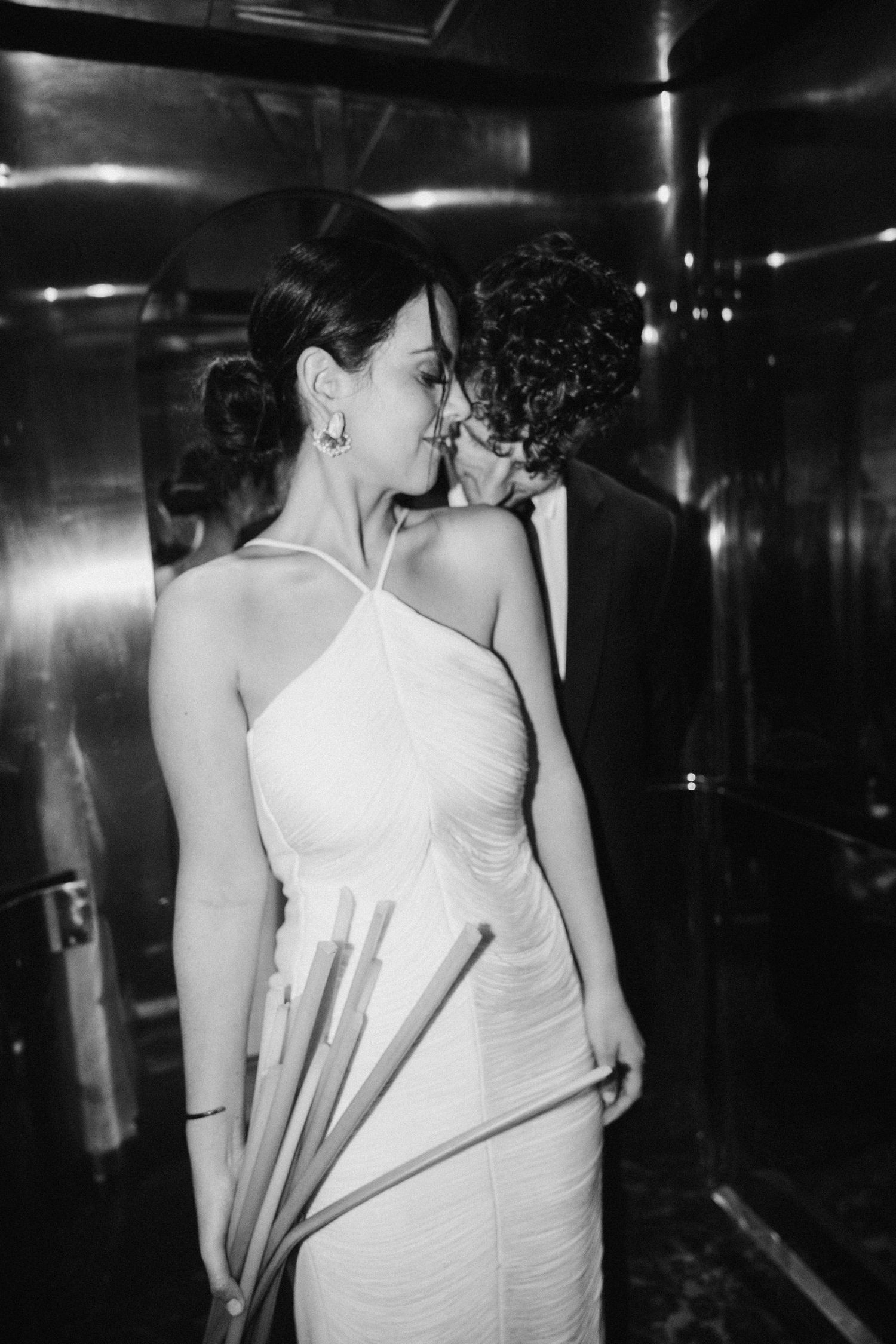 A series of black and white photos showing intimate moments in a dark interior space.