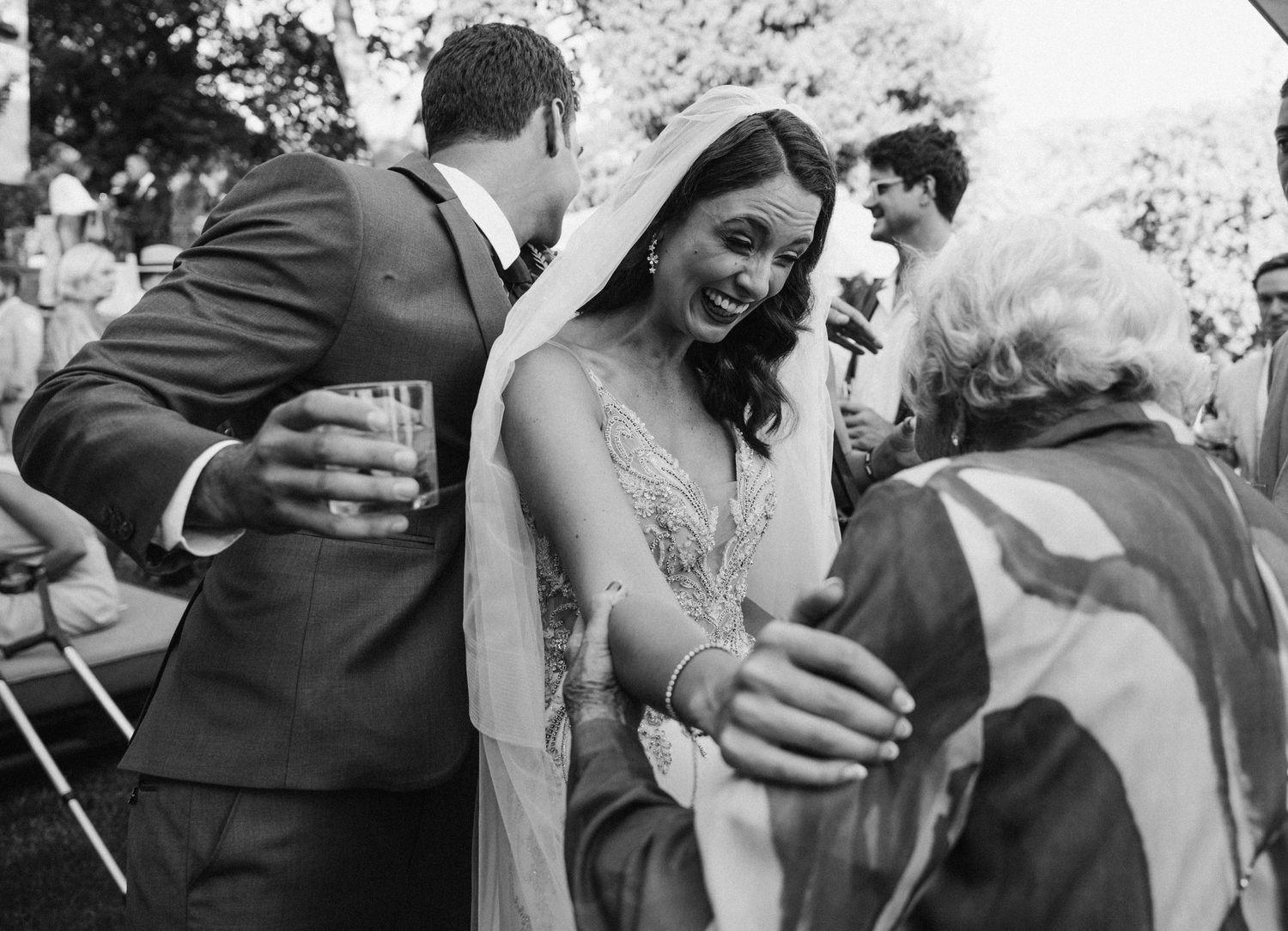 Emotional moment shared between wedding guests during outdoor reception.