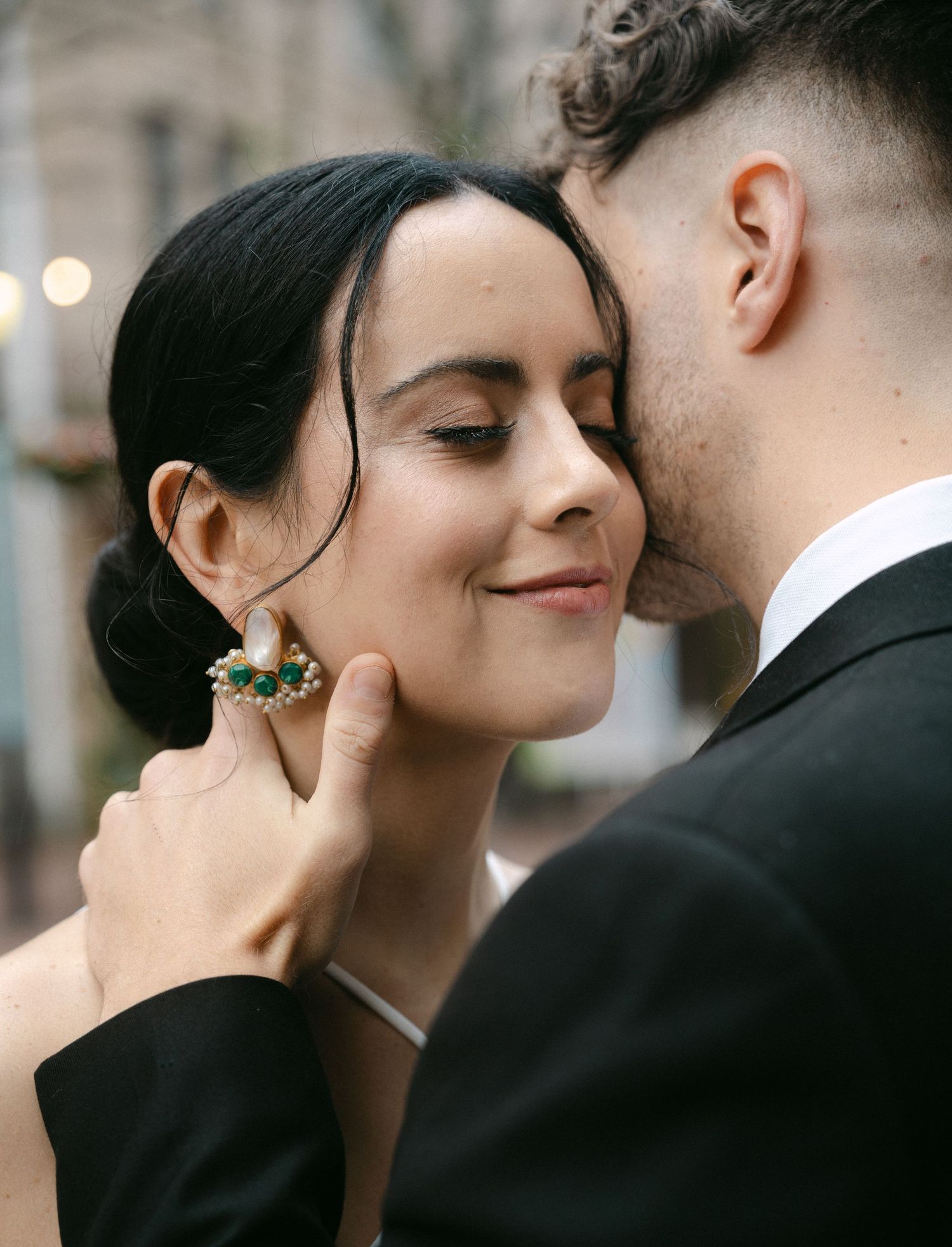 Elegant couple in formal wear share tender moments during their wedding photoshoot.