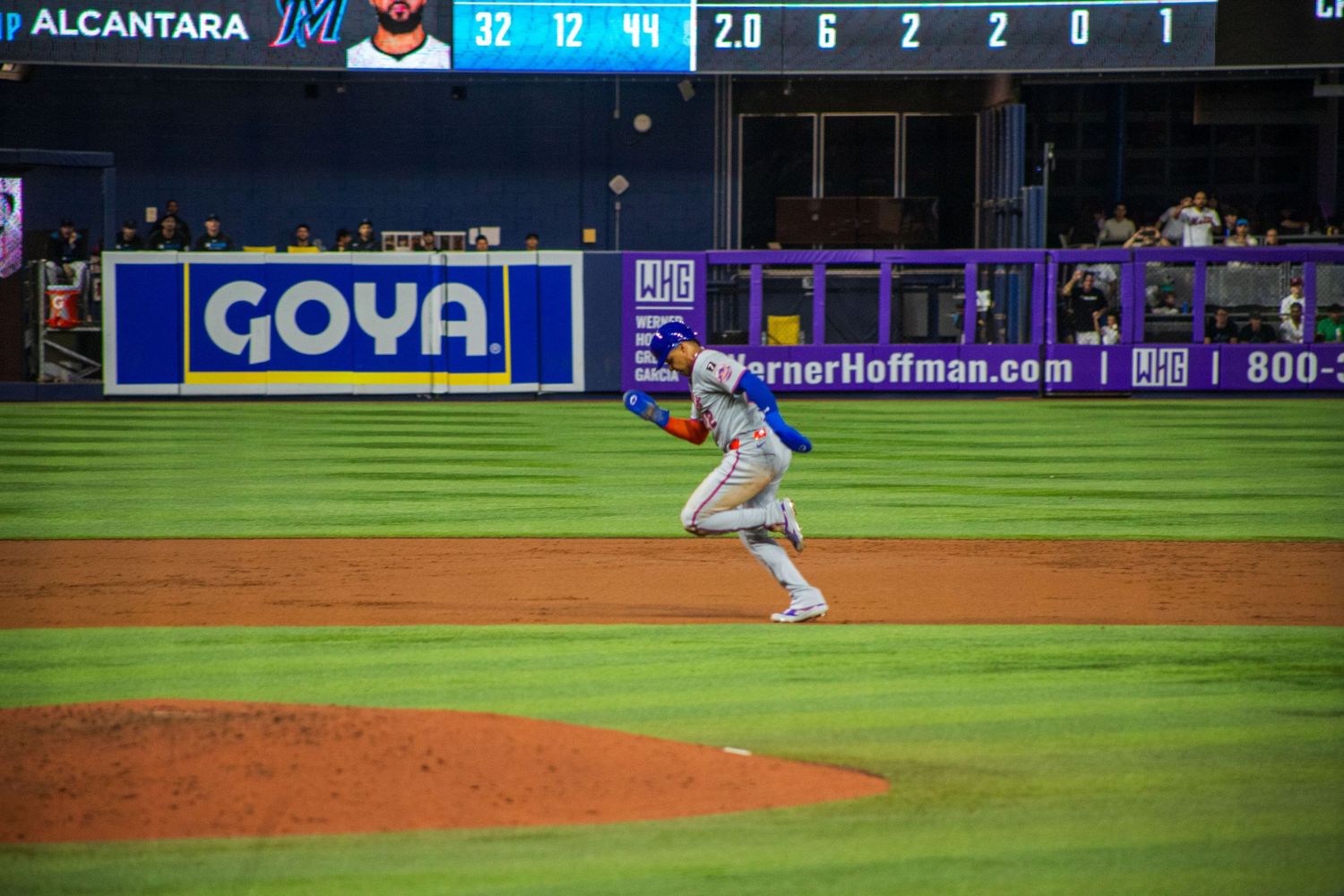 Baseball scoreboard displays game statistics with Alcantara's name during a nighttime match.