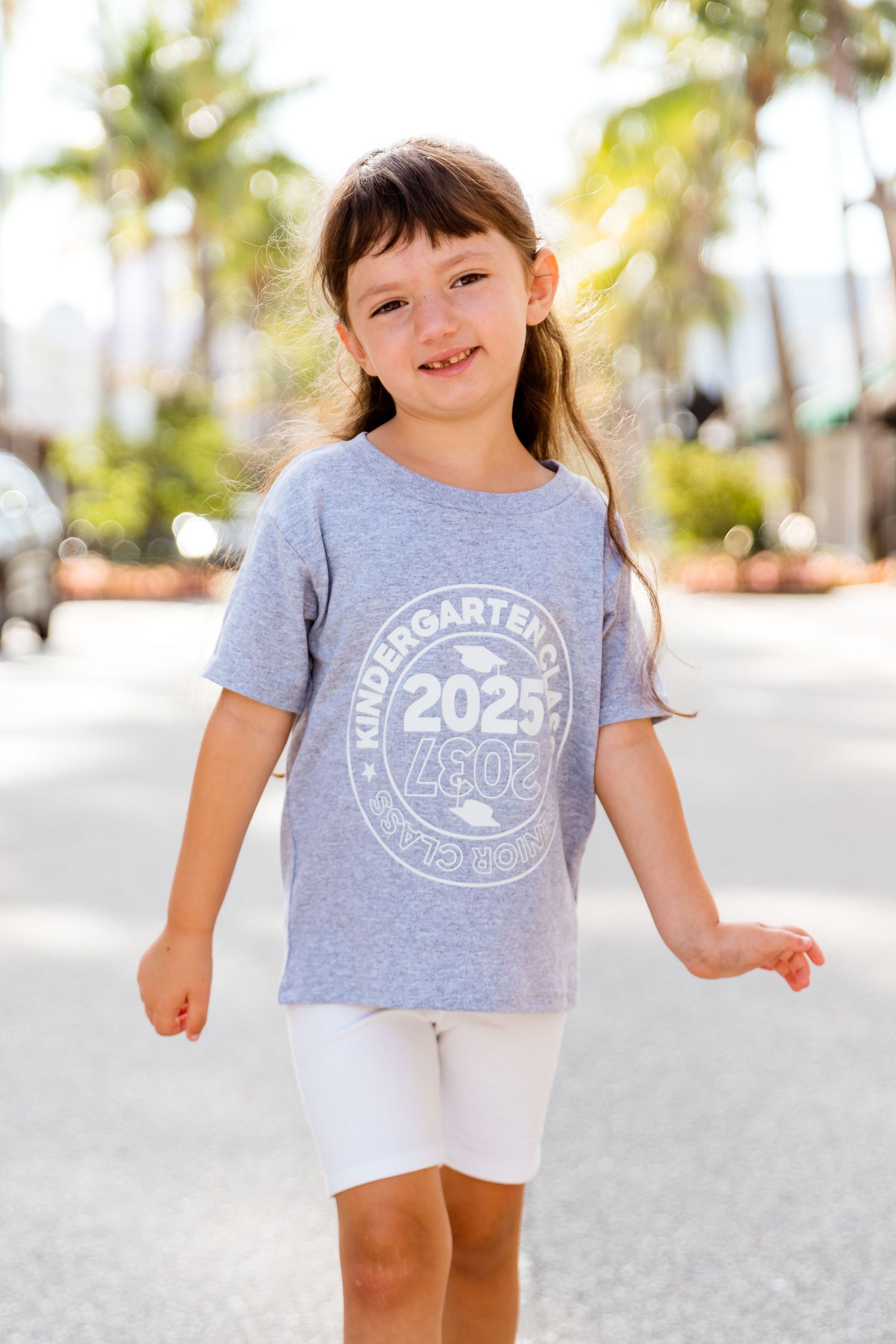 Young child wearing a gray graphic t-shirt with 