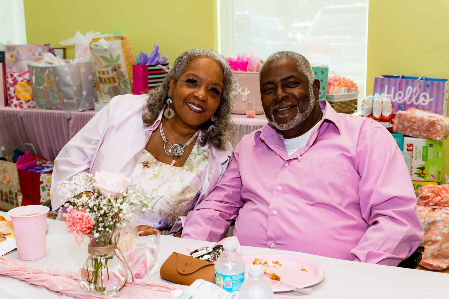 Guests enjoying refreshments at a pink-themed celebration event.