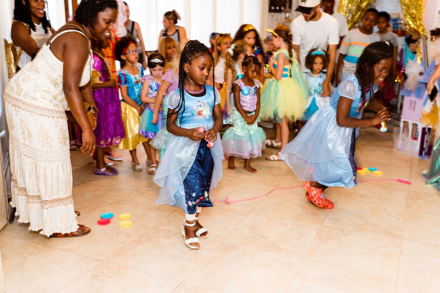 Children enjoy activities and games at a colorful indoor birthday party or celebration event.