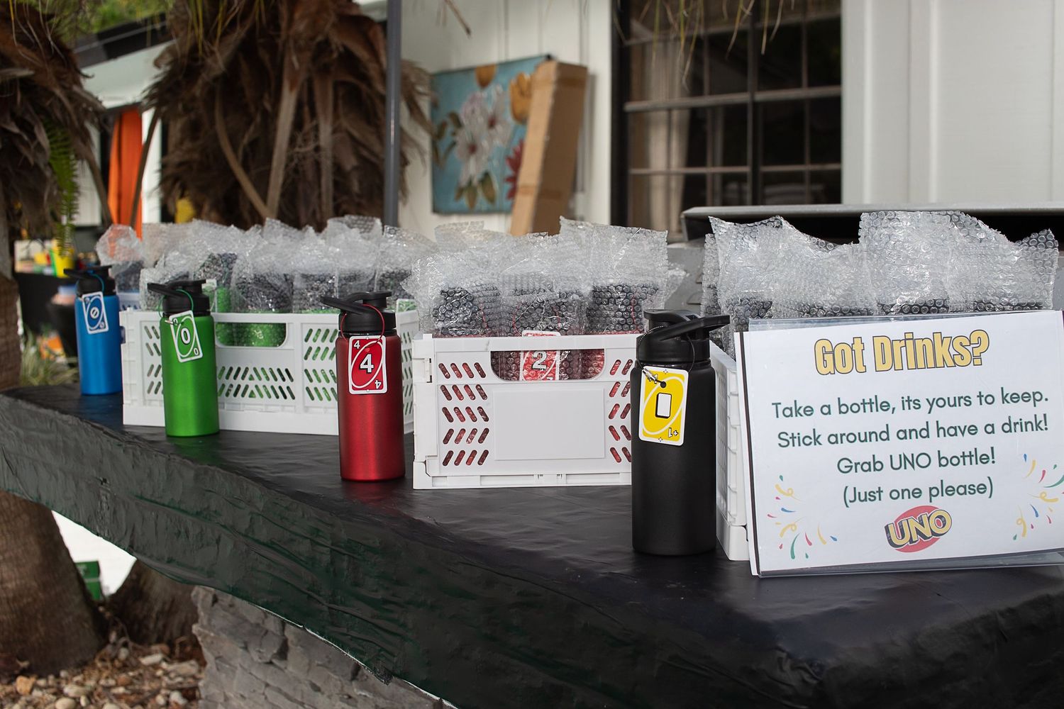 Row of party favor bags in different colors with UNO-themed game instructions.