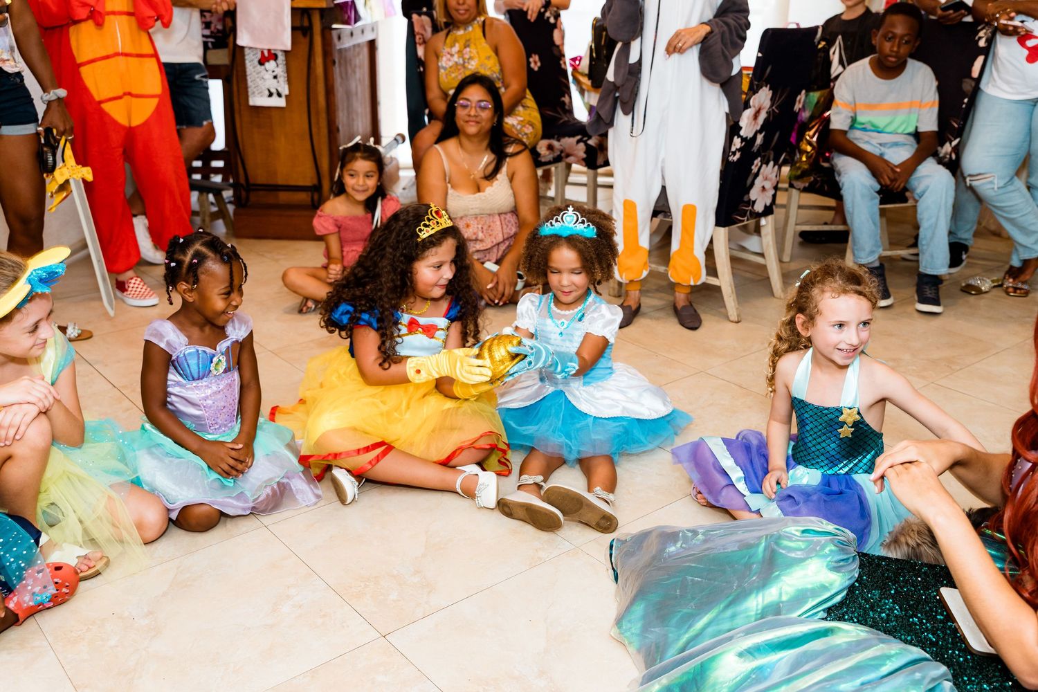 Group of party attendees gathered in celebration on tiled floor.