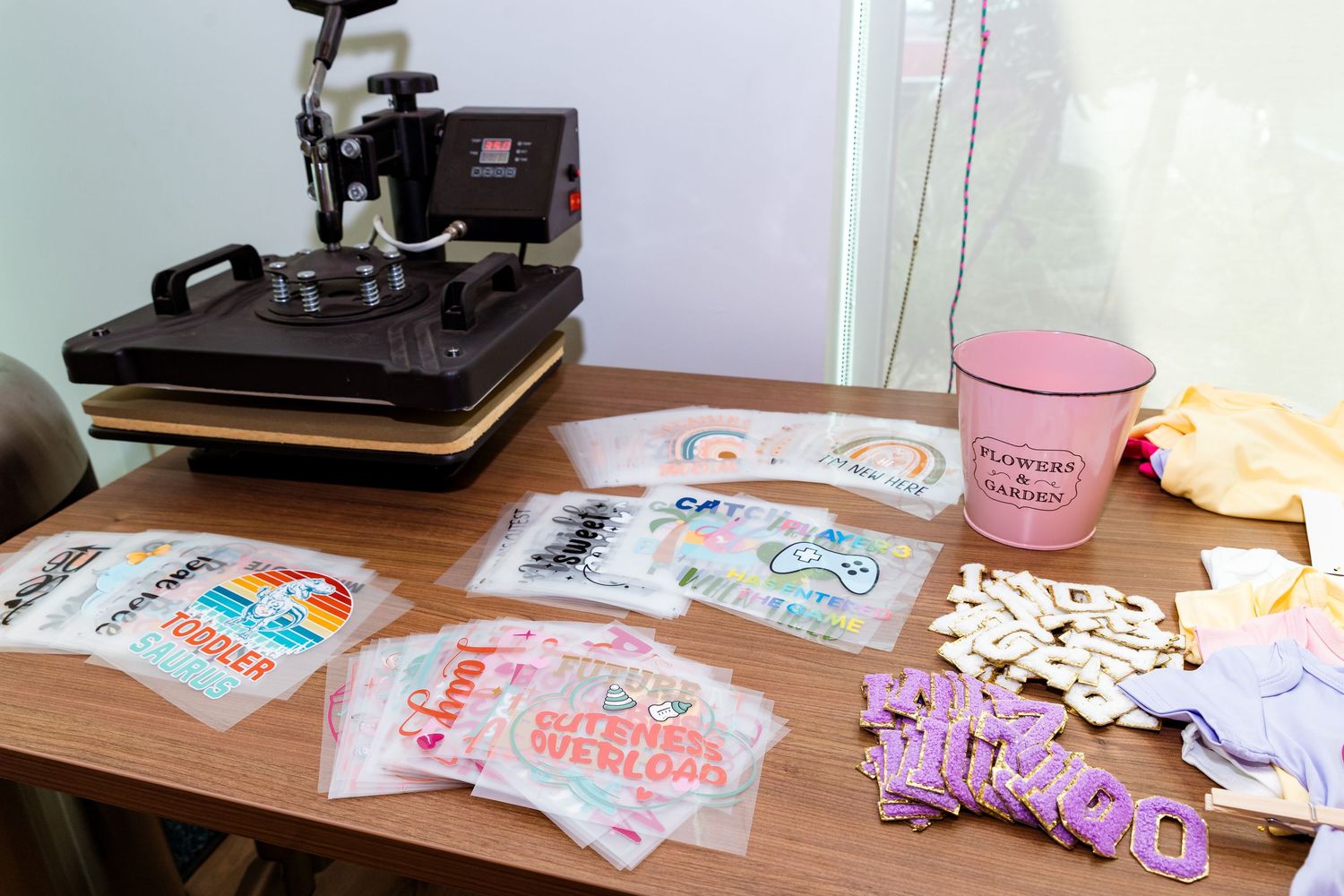 Kitchen counter setup with cooking equipment and pink decorative elements.