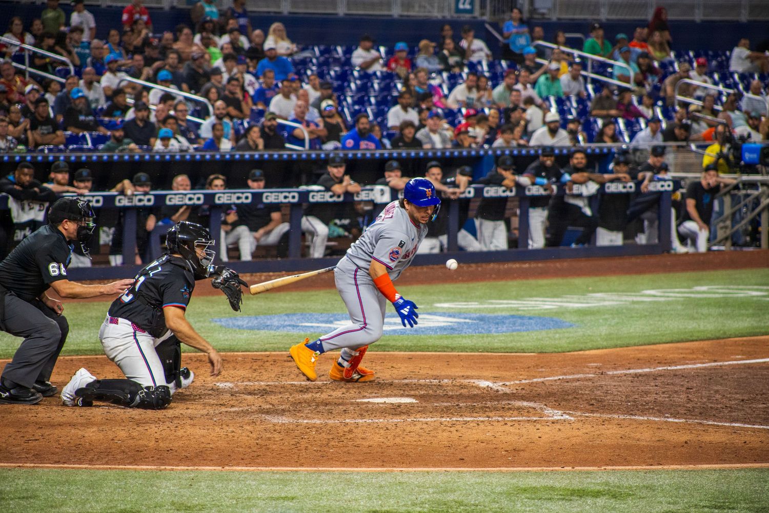 Multiple baseball plays at home plate shown in sequence during professional game.