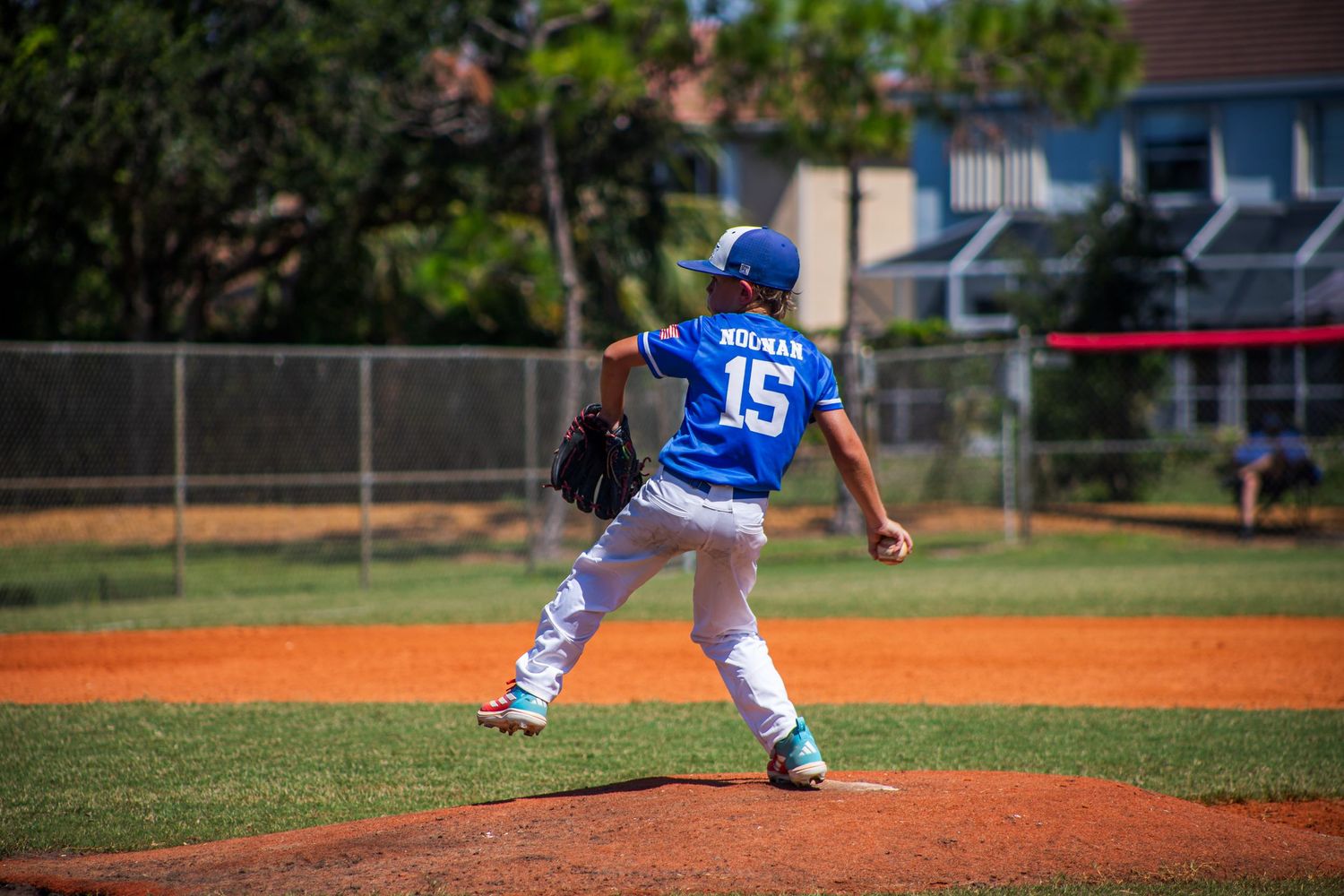 Baseball players perform a synchronized sequence showing how to pitch from base through the windup and delivery motion.