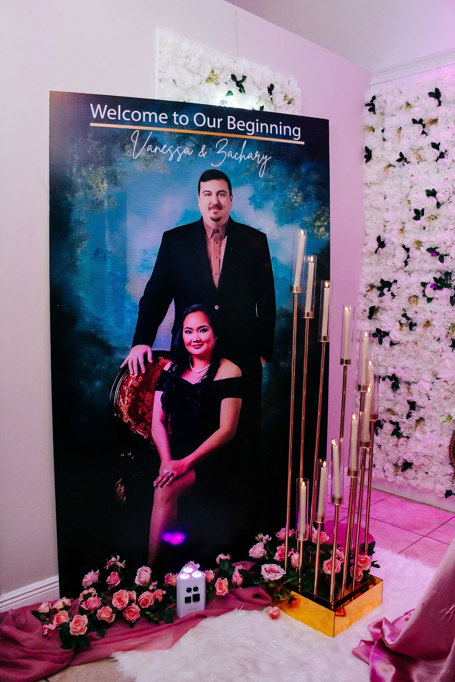 Formal event photo backdrop setup with white Christmas tree, gold decor and romantic purple lighting for special occasion.