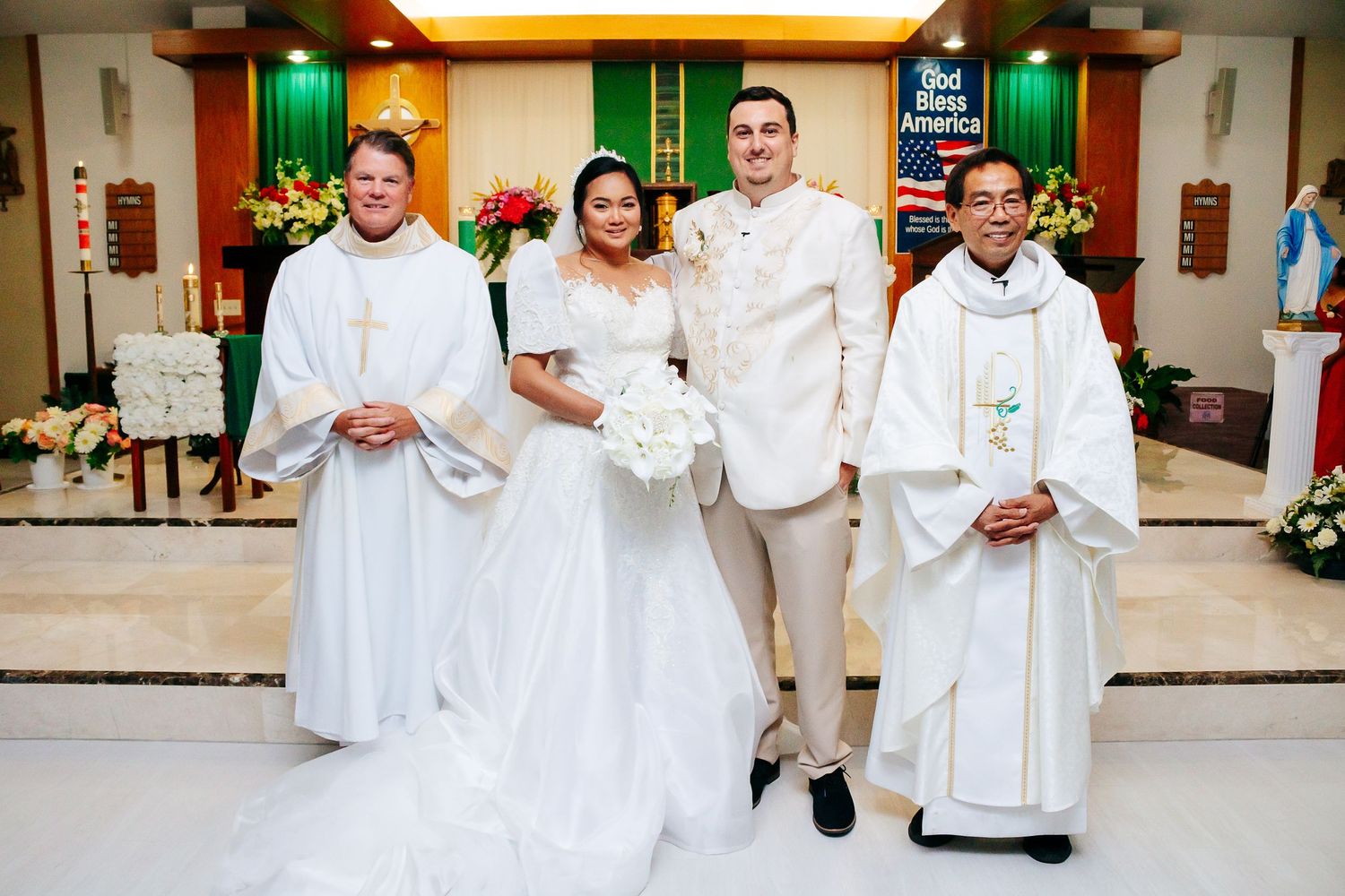 People in white ceremonial attire standing in a church or chapel during a religious service.