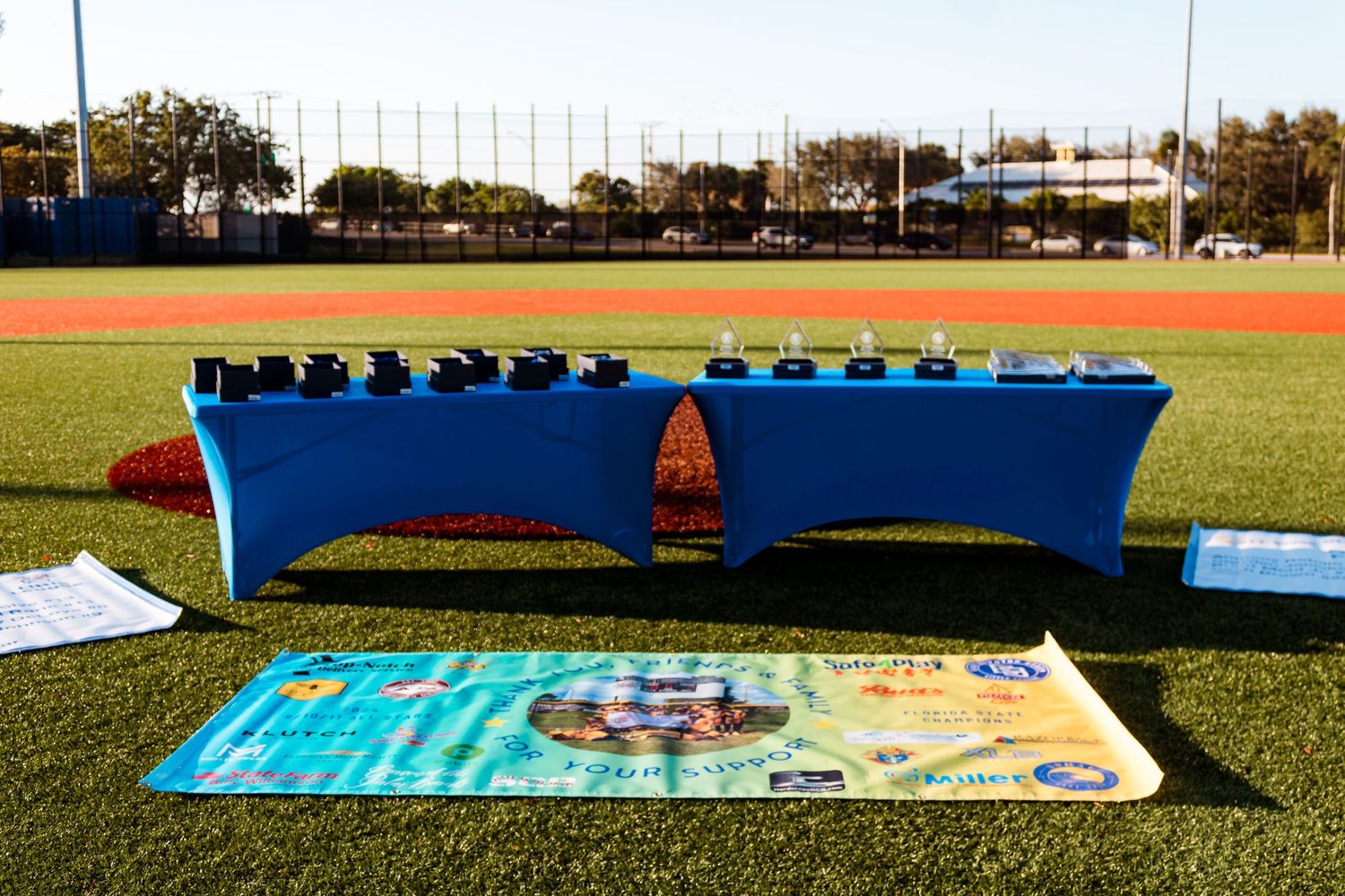 Baseball equipment and banner display setup on grass field.