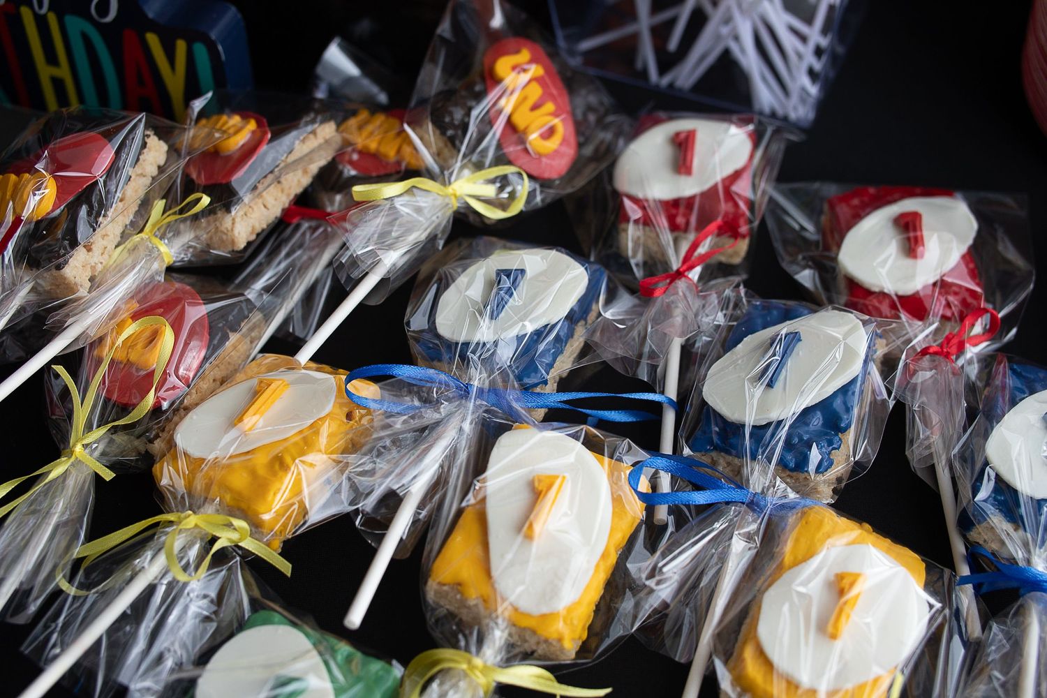 Wrapped lollipops with UNO card designs arranged in neat rows.