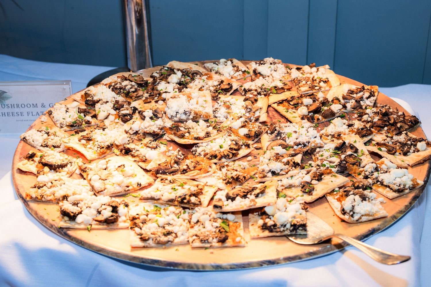 A large platter of appetizers or hors d'oeuvres arranged on a white serving board.