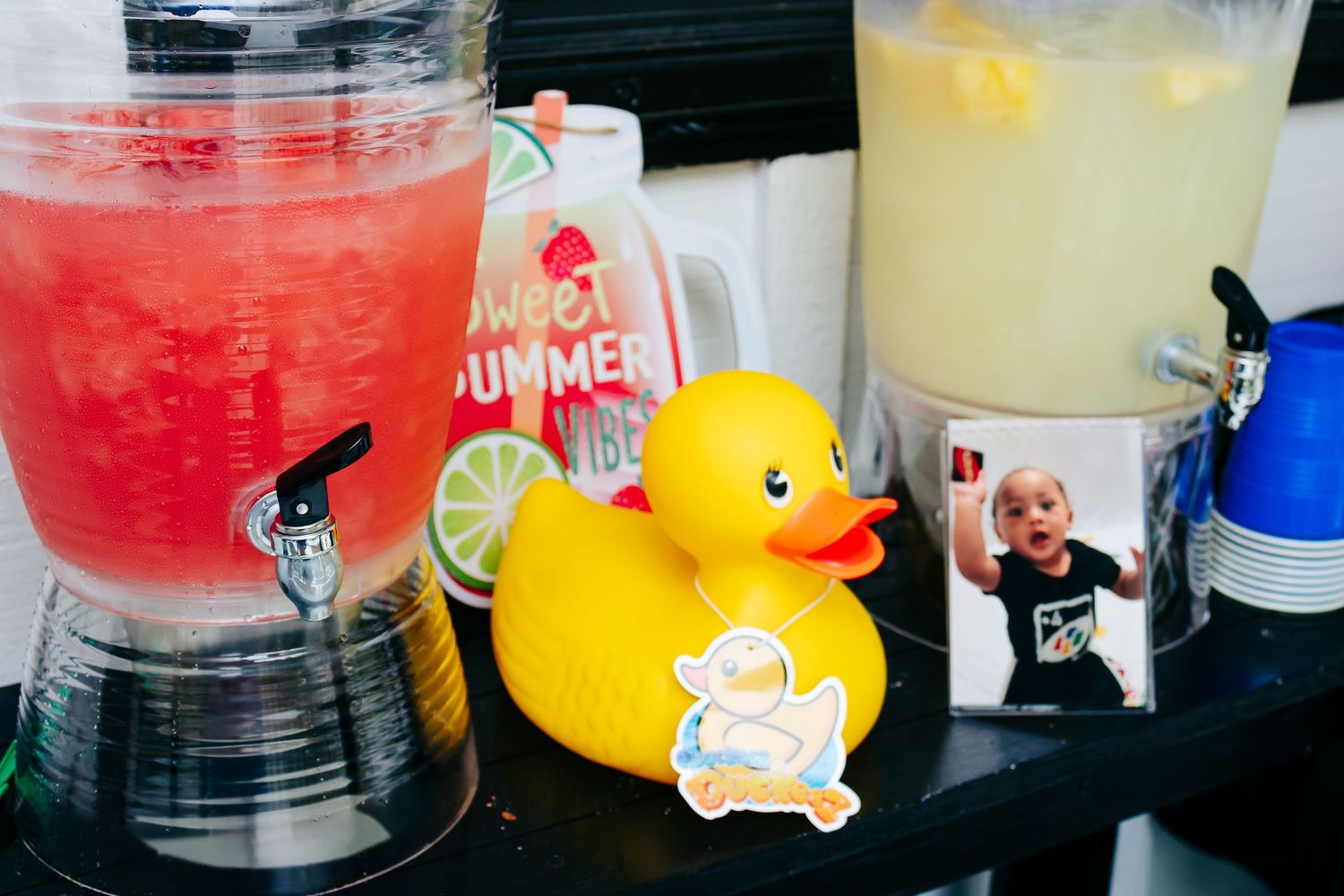 Assorted party drinks and beverages with a yellow rubber duck decoration on display.