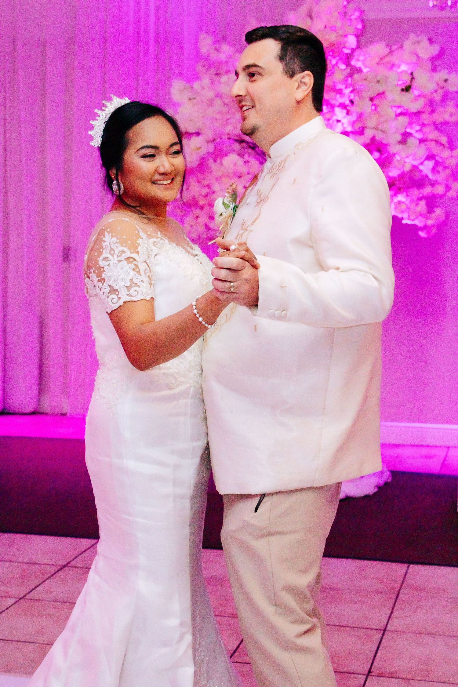 Happy couple shares intimate dance moment at their wedding reception.