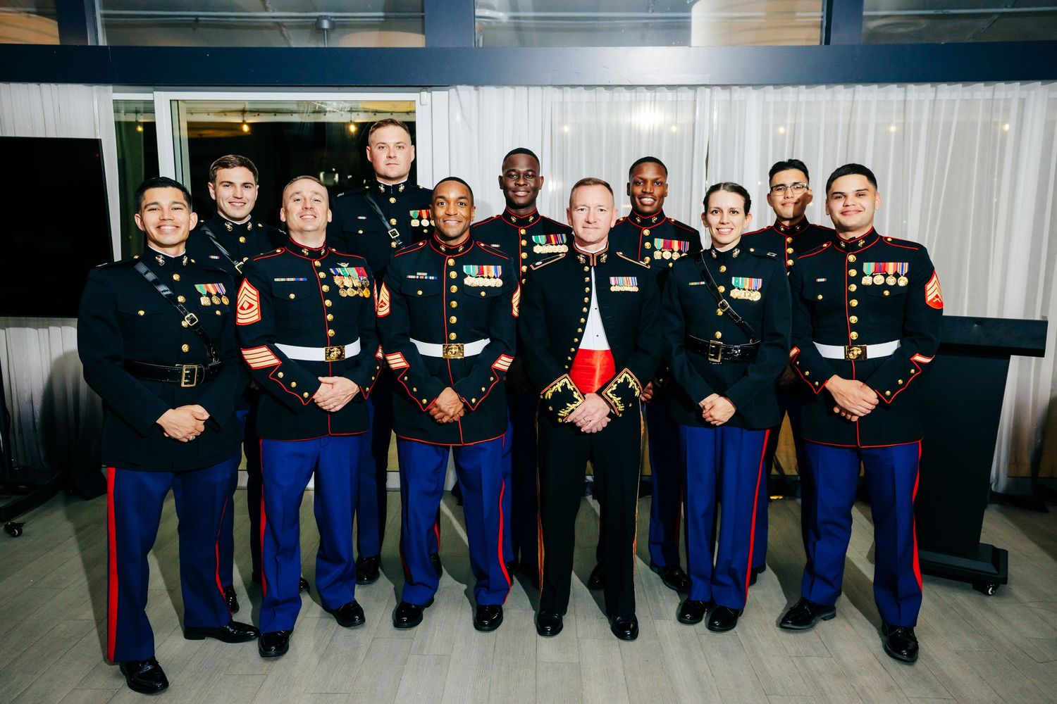 Group photo of military service members in dress uniforms standing together for a formal portrait.