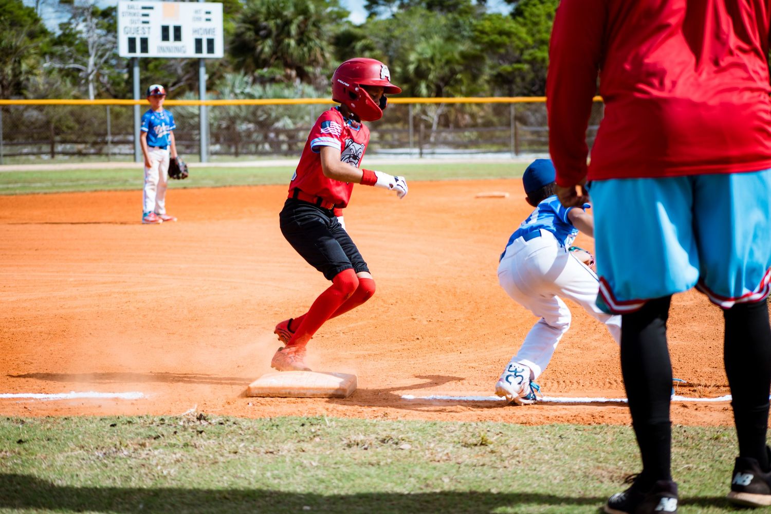 Players on a baseball diamond slide into bases during an intense game sequence.