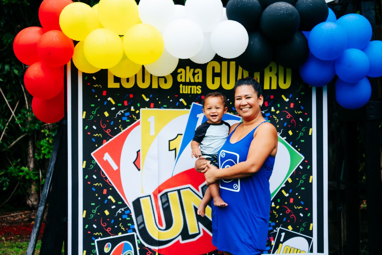 Colorful balloon arch decorations in red, yellow, white and blue create a festive party atmosphere.