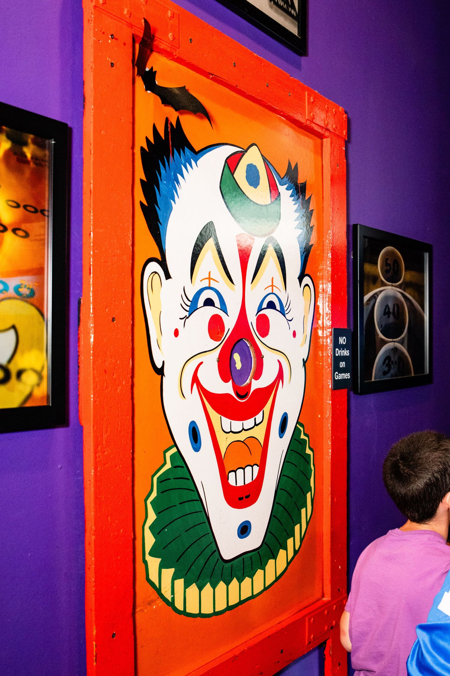 A vibrant and colorful clown face is displayed on a wall, creating a whimsical and playful atmosphere.
