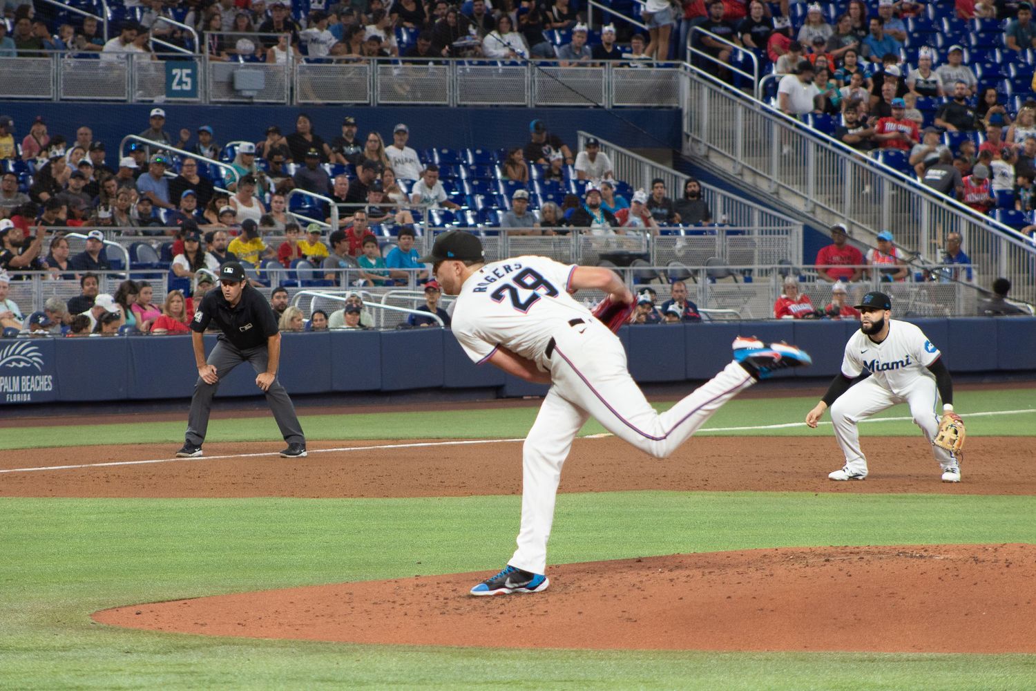 Baseball pitcher in mid-delivery motion on the mound during a professional game.