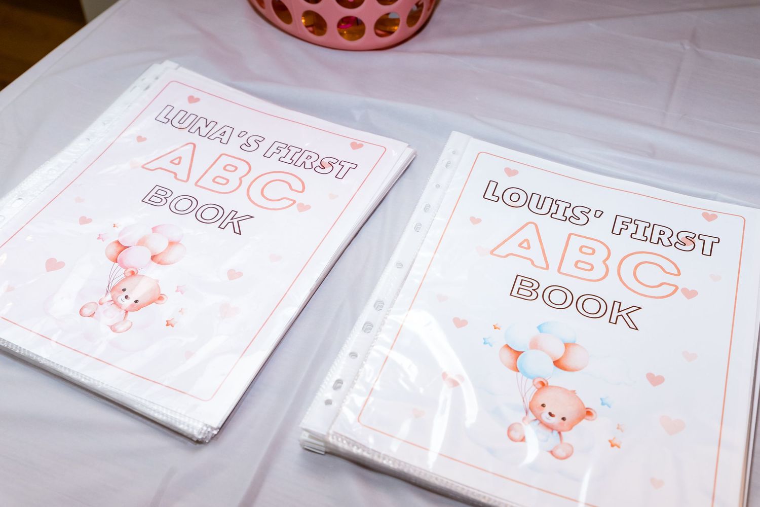 Two white books with pink lettering and cartoon bunny illustrations labeled as ABC Book on the covers.