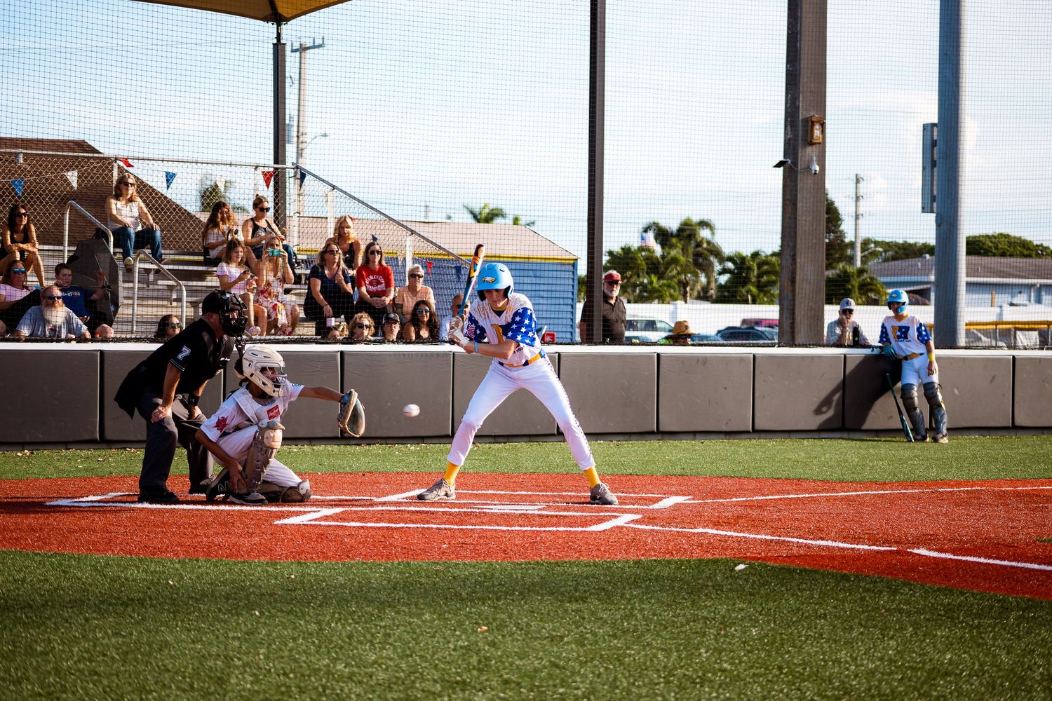 Baseball players in action during multiple stages of a game, showing batting, fielding and pitching sequences on a sunny day.