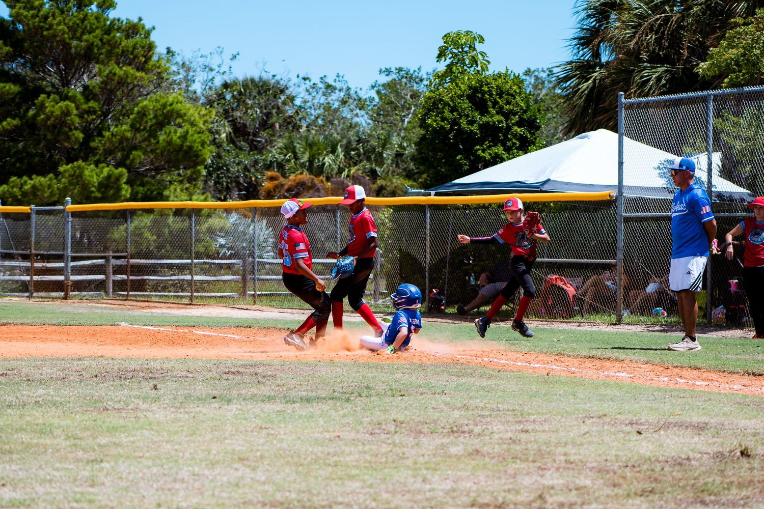 Baseball players in red uniforms running across the diamond during a game.