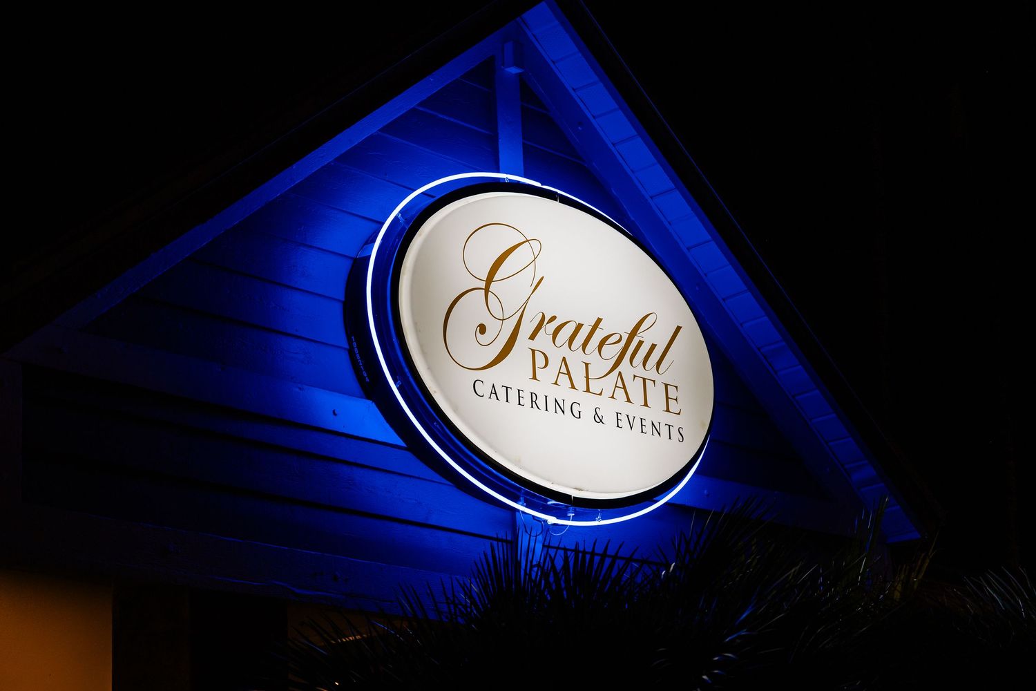 Illuminated blue event signage and lighting creating ambiance at upscale venue.