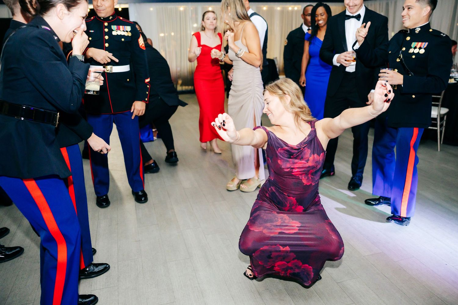 Couples dancing and celebrating at formal military event with elegant evening attire.