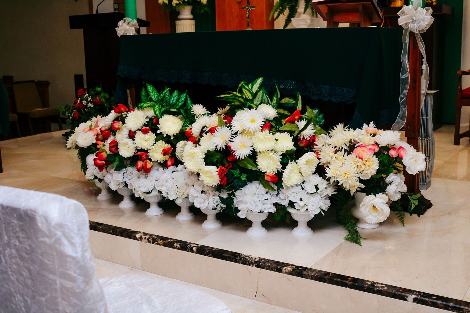 Stunning floral arrangement with white and pink blooms decorating an event space.