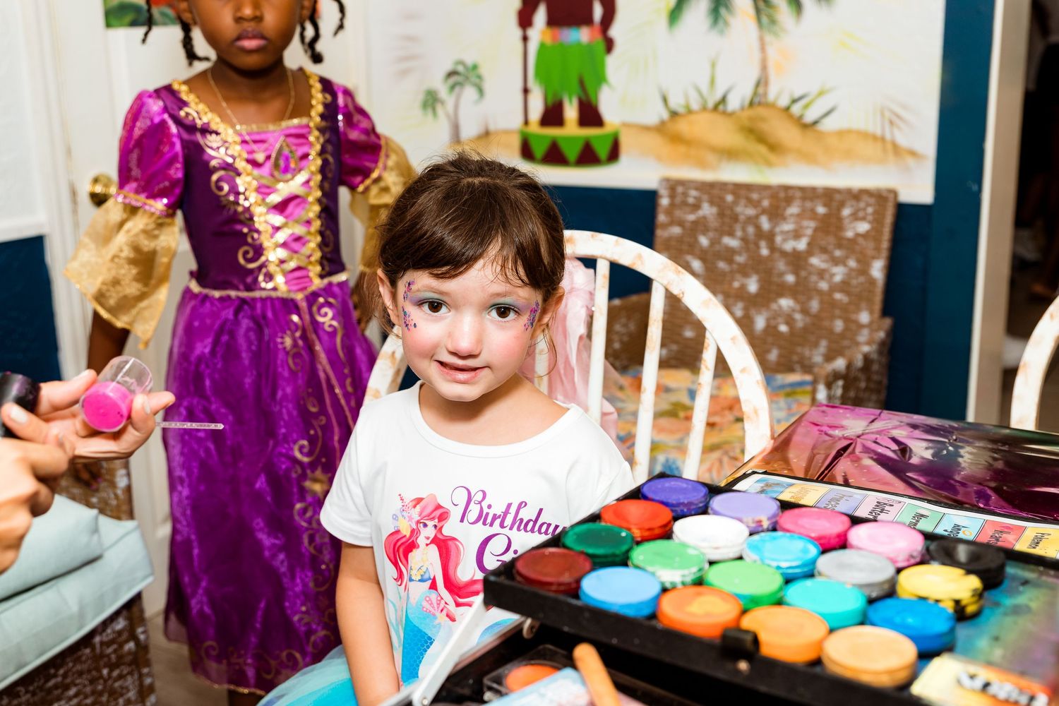 Colorful cupcake display at princess themed birthday party with decorations.