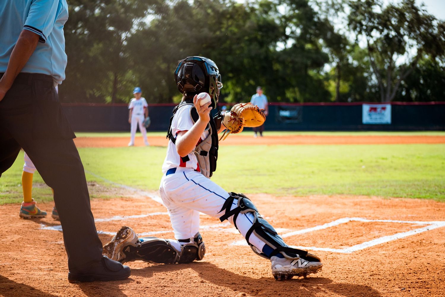 A set of close-up photos showing baseball players sliding into home plate as catchers attempt to make tags.