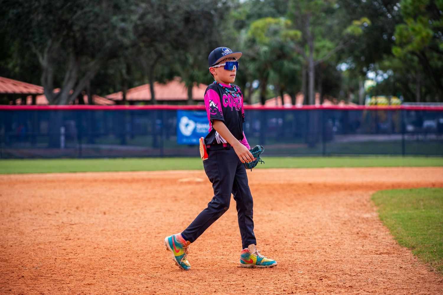 A series of baseball players in action on a dirt infield during practice or gameplay.