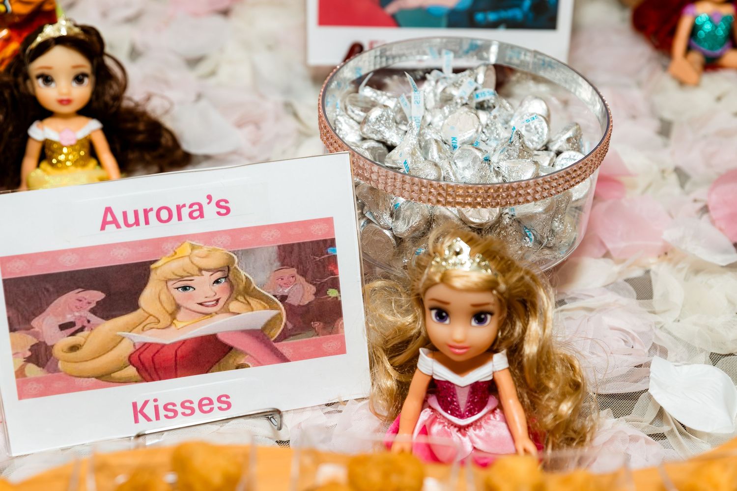 Disney Princess Aurora doll and themed display with glittery decorations at a princess party.