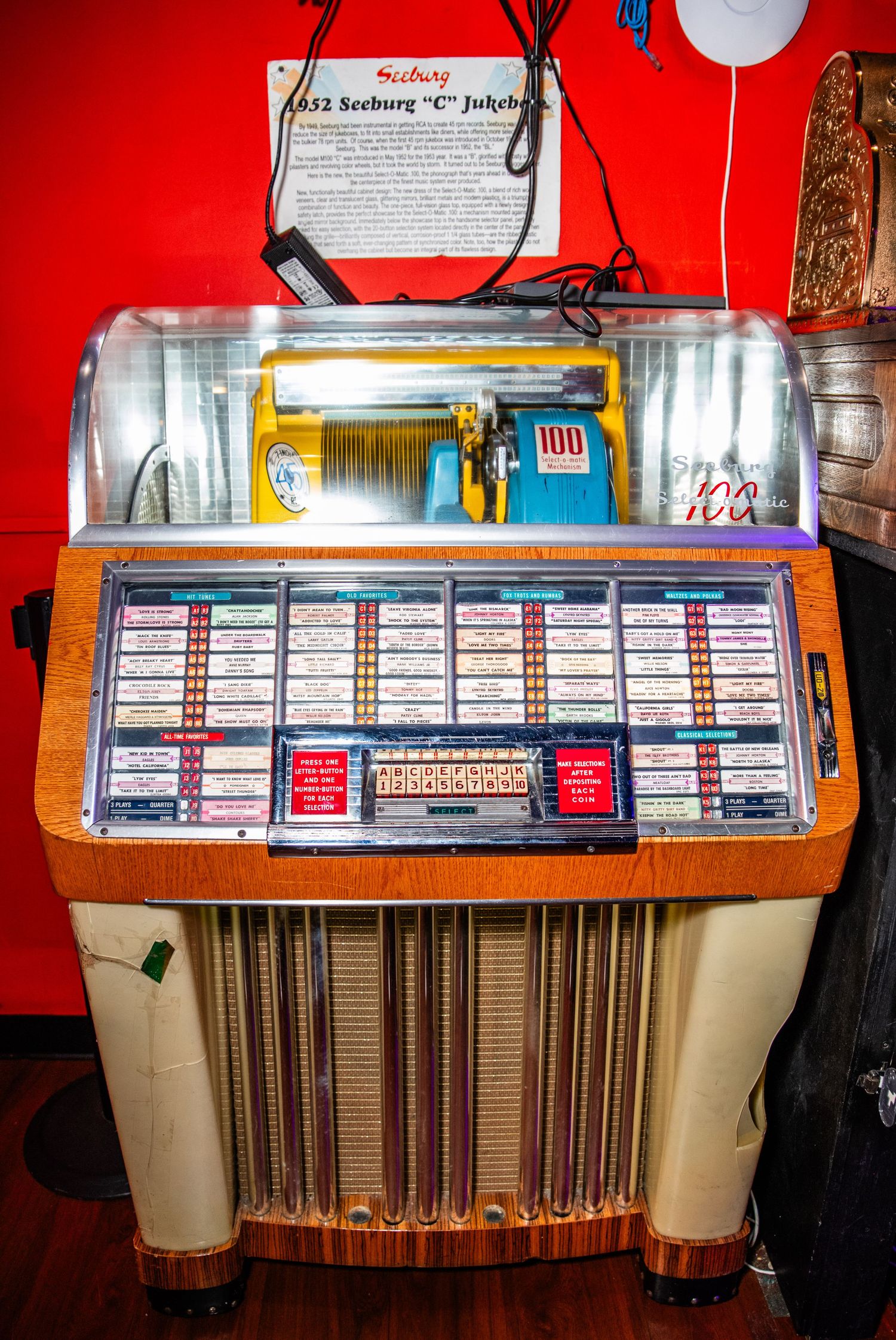 An old-fashioned jukebox with a colorful display and various buttons and controls.