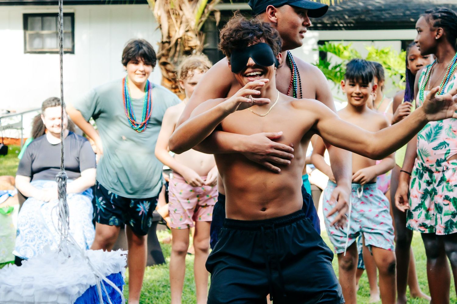 People playing with water and having fun outdoors during a summer gathering.