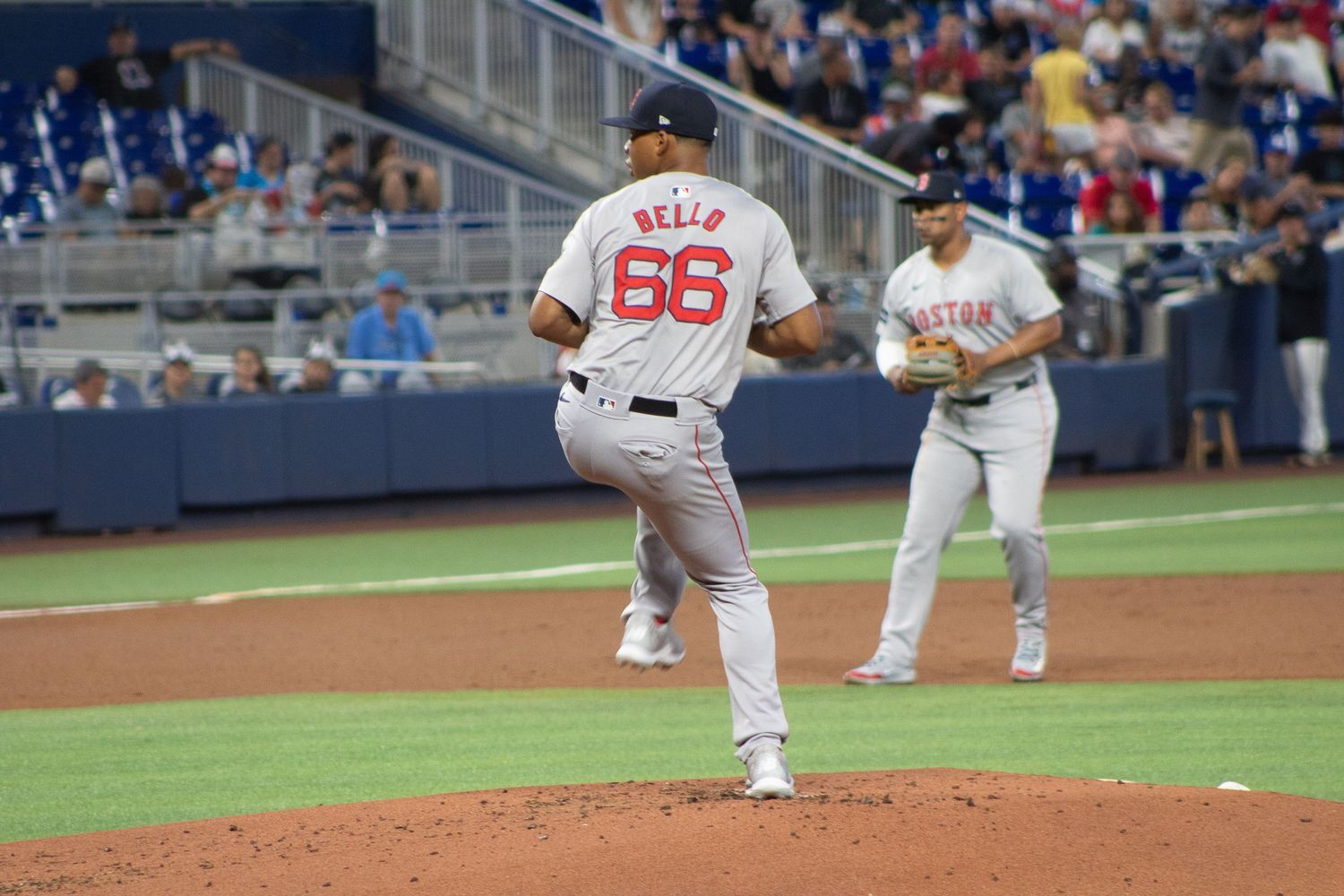 A pitcher wearing jersey number 66 delivers a pitch from the mound.