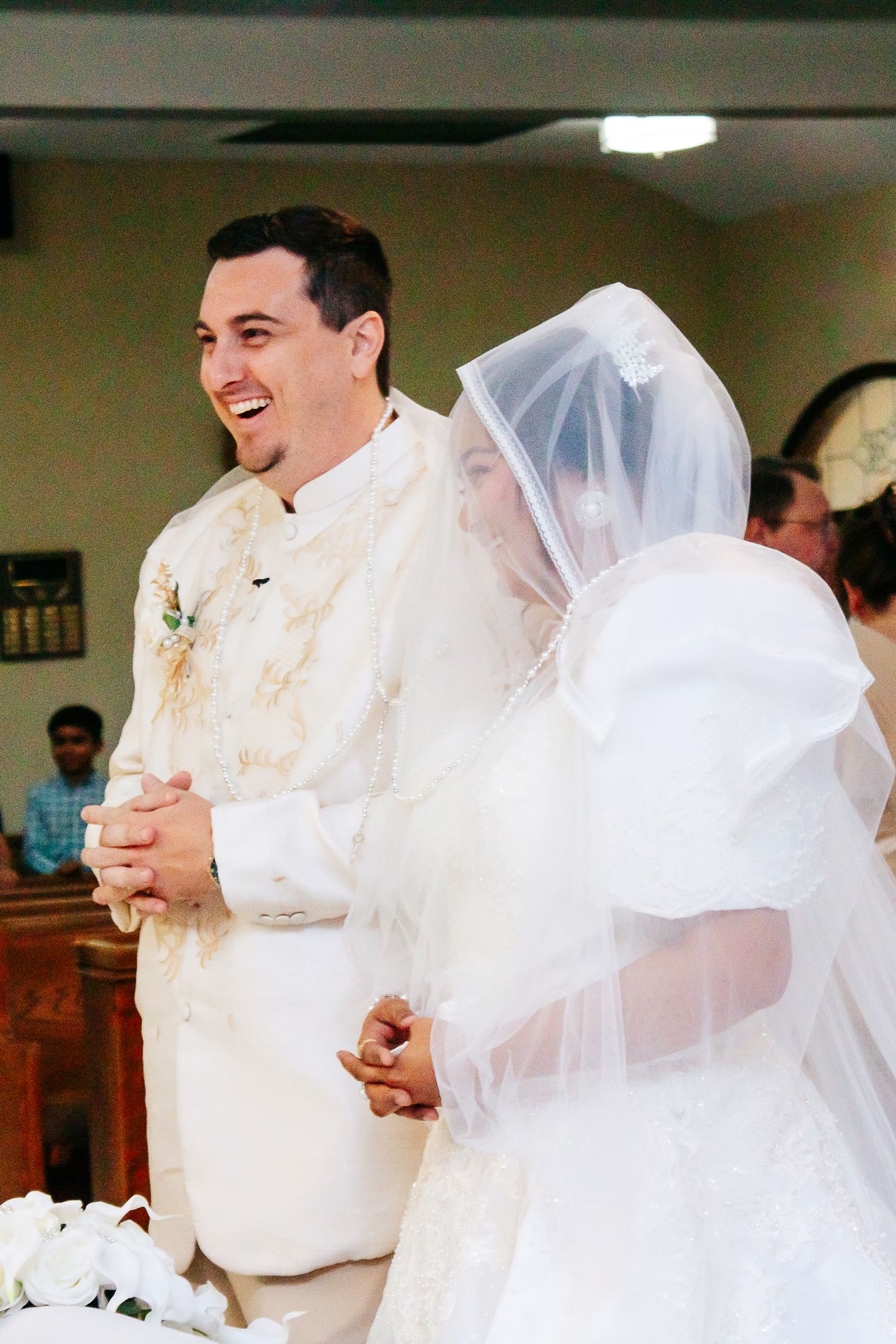 A joyful first dance sequence between newlyweds with the bride's white veil flowing during their wedding celebration.