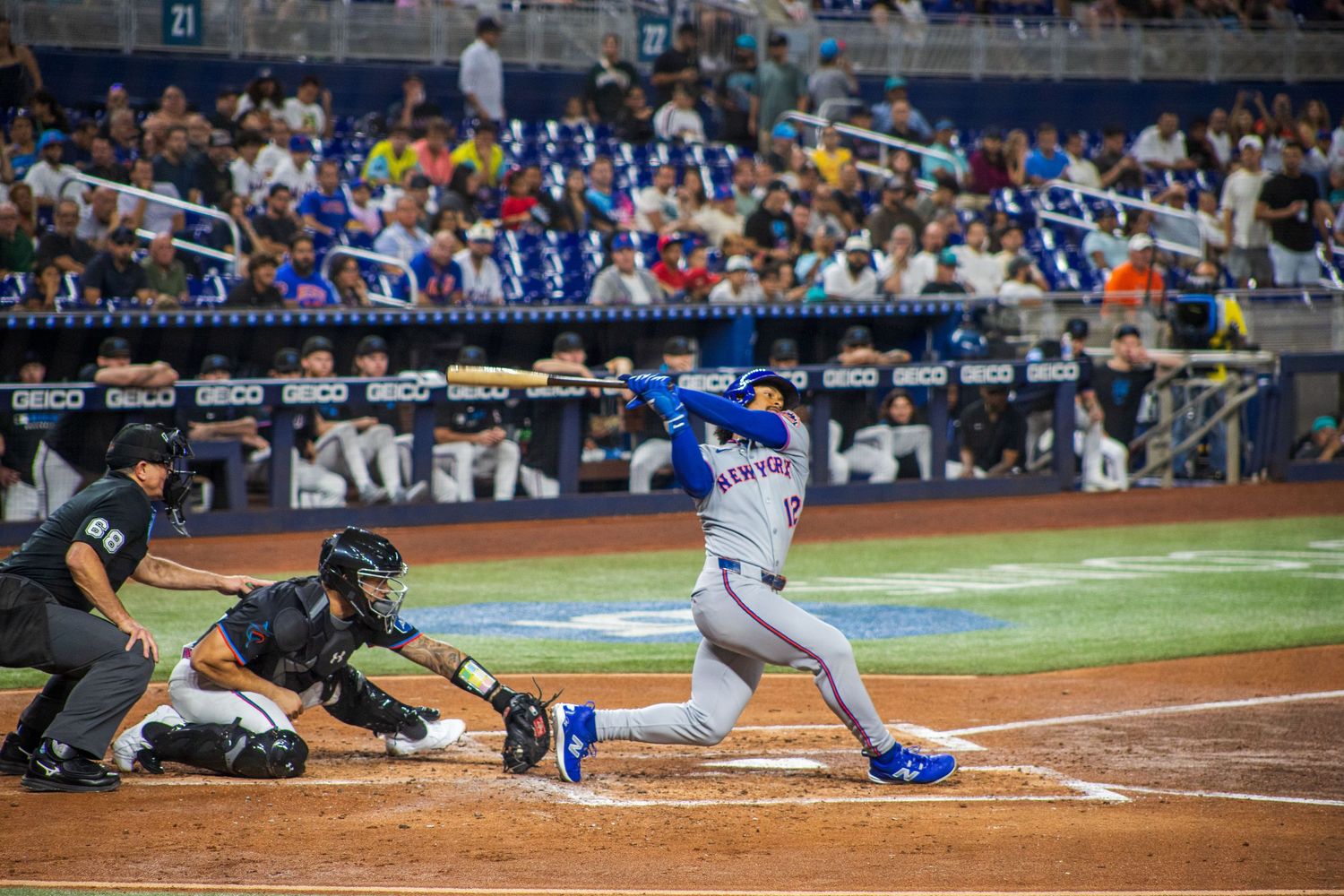 Baseball players compete in a sequence of action shots at home plate during a professional game.