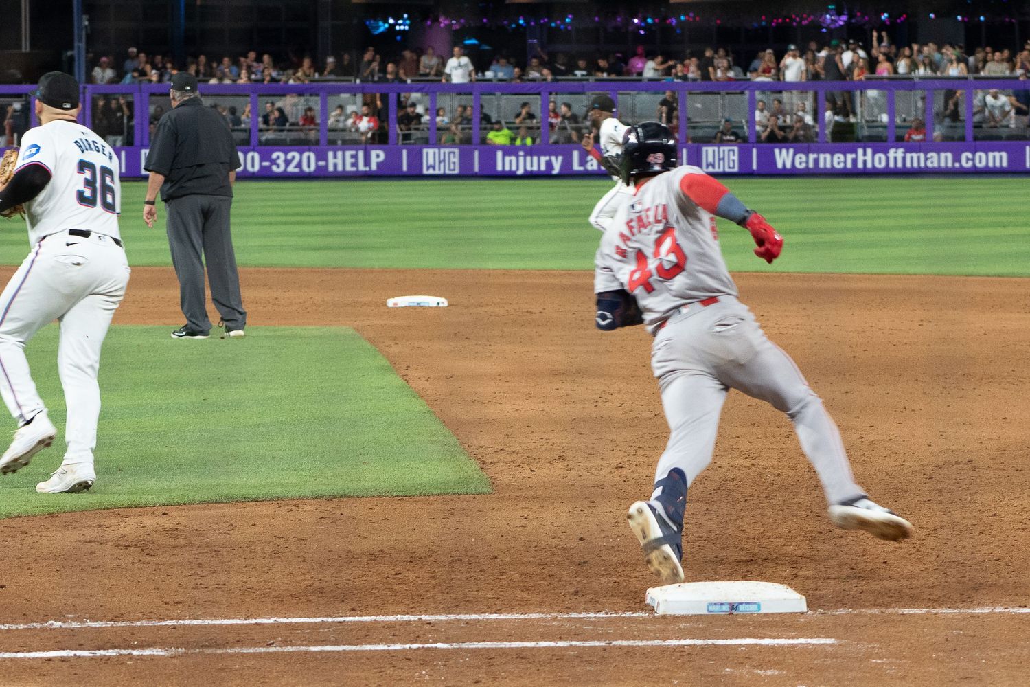 Jarren Duran running past first base during game action.