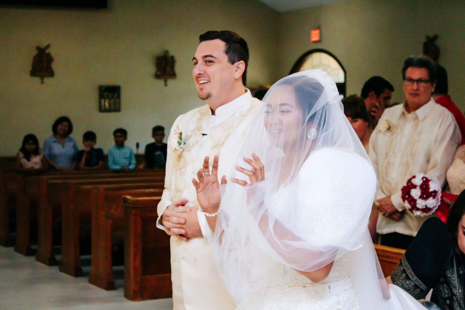 An elegant couple shares their first dance together at their wedding ceremony inside a church.