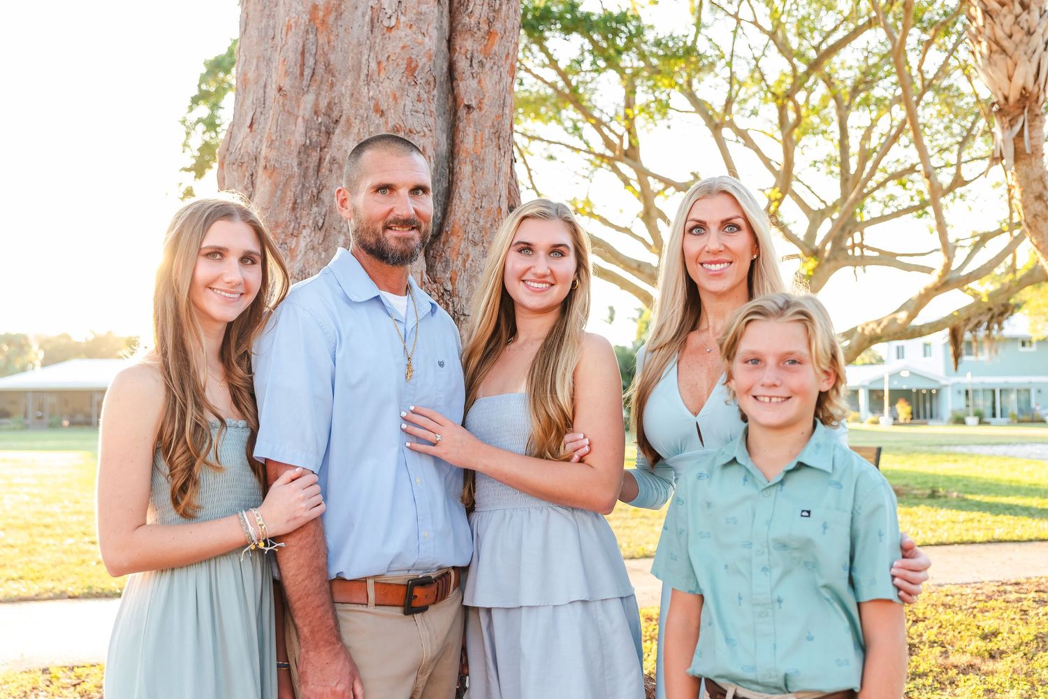 Casual family beach photos with everyone wearing coordinated blue and mint colored clothing.