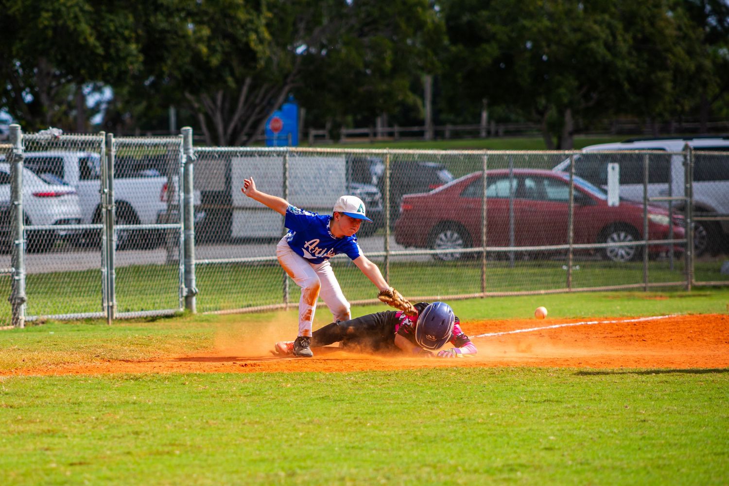 Baseball players in action during a game with multiple sliding plays and defensive positions on the field.