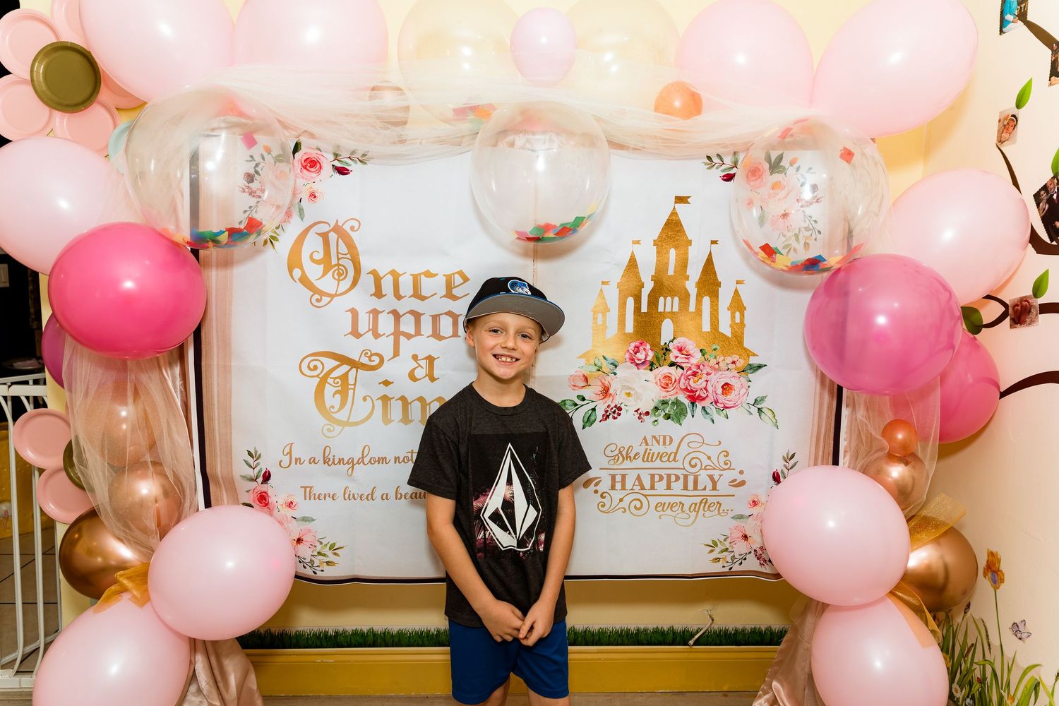 Pink and gold balloon arch decorations at a princess-themed party event.