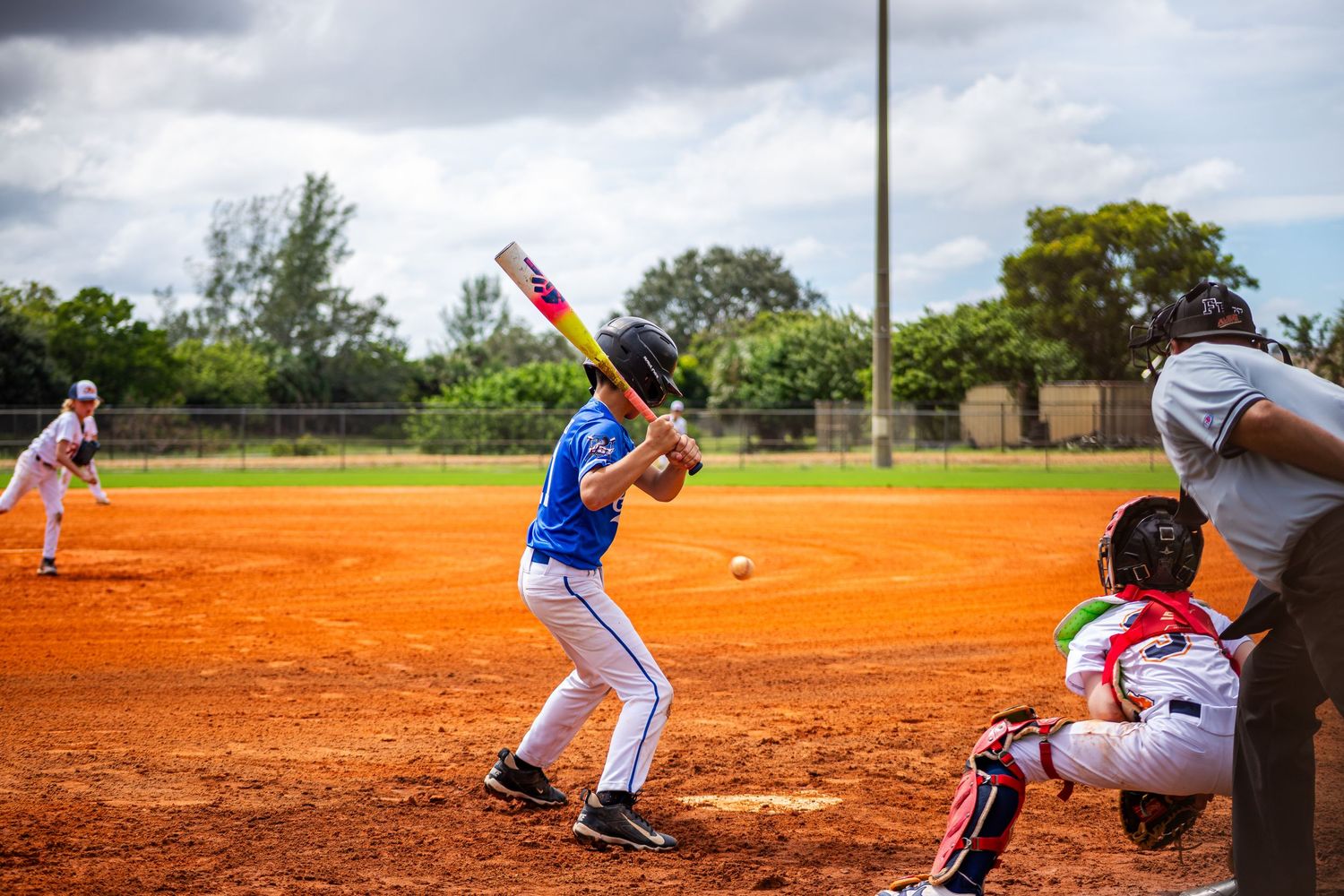 Baseball action sequence showing players in motion on a red clay diamond during a game.