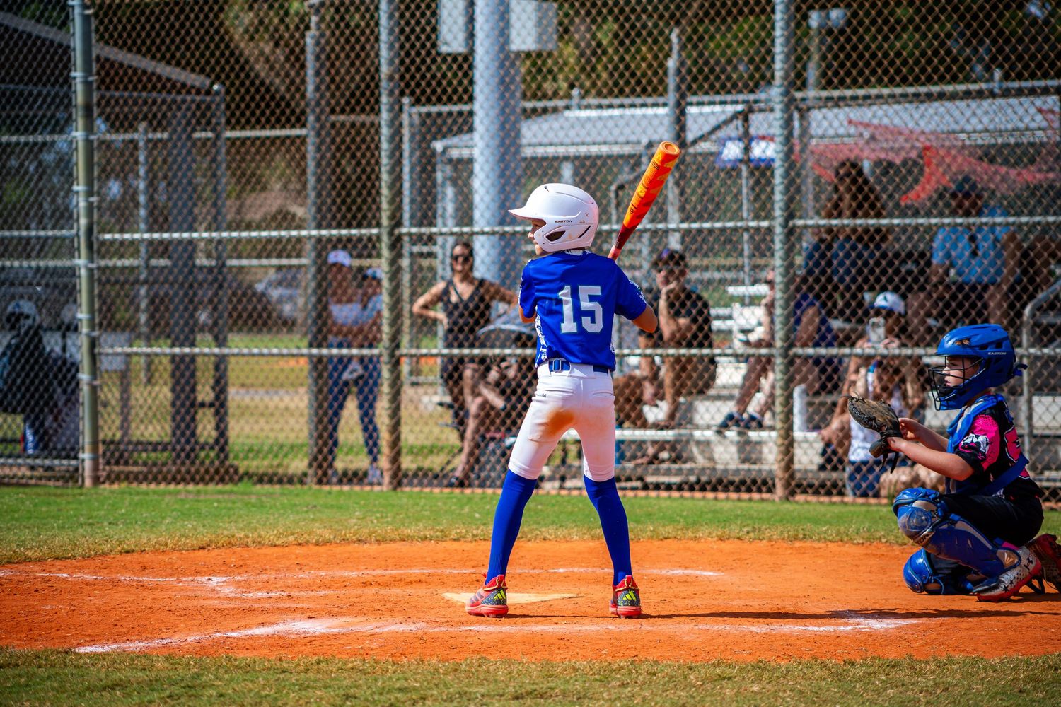 Baseball players in action during a game showing batting, fielding and pitching sequences on a sunny day.
