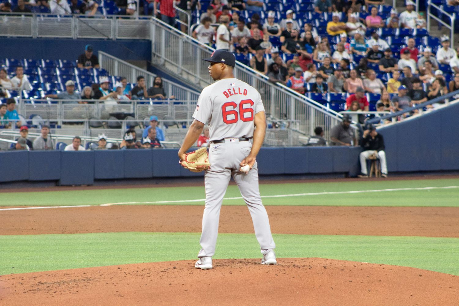 A pitcher stands on the mound in a white uniform with number 66.