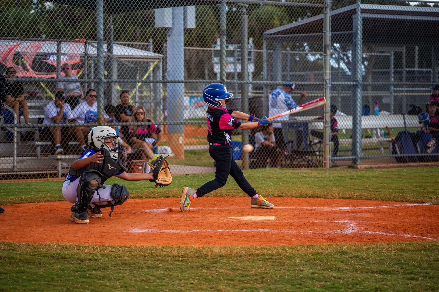 A sequence of softball game action shots showing batting, catching and fielding plays on a dirt diamond field.